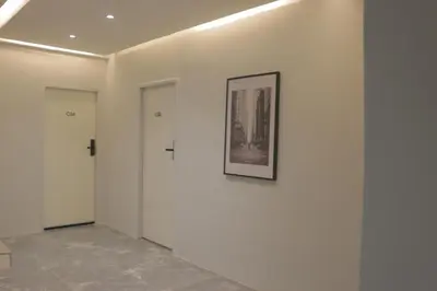 a hallway with white walls and a picture on a wall at Nato House Ekkamai -BTS Ekkamai with balcony in Bangkok