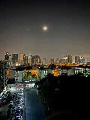 a city at night with cars parked in a parking lot at APARTMENT A4 DINDAENG in Bangkok