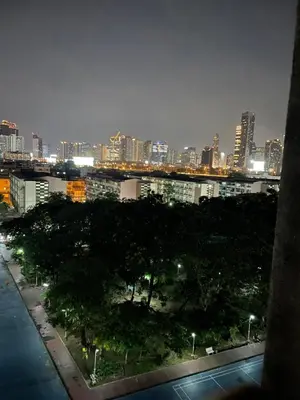 a city skyline at night with trees and buildings at APARTMENT A4 DINDAENG in Bangkok