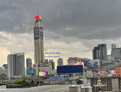 a tall skyscraper with a city in the background at APARTMENT A4 DINDAENG in Bangkok