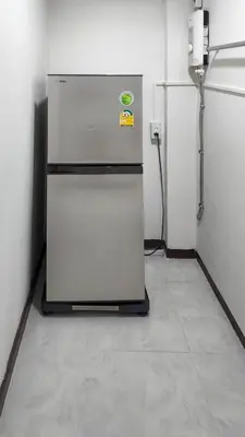 a refrigerator sitting in a room with a wall at APARTMENT A4 DINDAENG in Bangkok