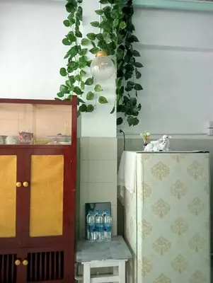a kitchen with a table and a potted plant at Ban Suanlum in Bangkok