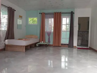 a bedroom with a bed in a room at Ban Suanlum in Bangkok