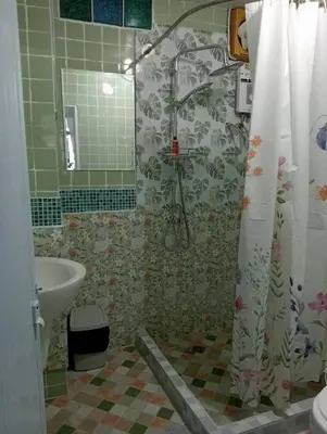 a bathroom with a shower and a sink at Ban Suanlum in Bangkok