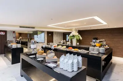 a restaurant with a buffet line with food on display at Best Western Nada Don Mueang Airport hotel in Bangkok