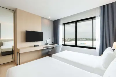 a hotel room with two beds and a television at Best Western Nada Don Mueang Airport hotel in Bangkok