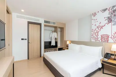 a bedroom with a white bed and a television at Best Western Nada Don Mueang Airport hotel in Bangkok