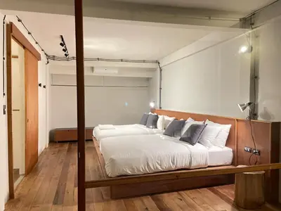 a bedroom with a large bed with white sheets and pillows at GalileOasis Boutique Hotel in Bangkok