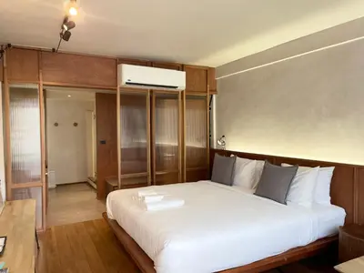 a bedroom with a large white bed in a room at GalileOasis Boutique Hotel in Bangkok