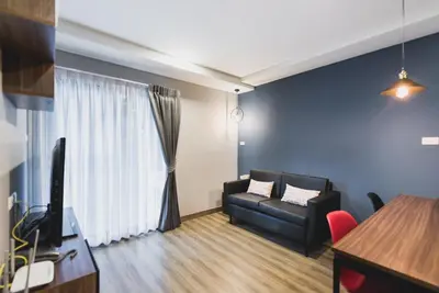 a living room with a couch and a window at W2 RESIDENCE in Ban Zong Katiam