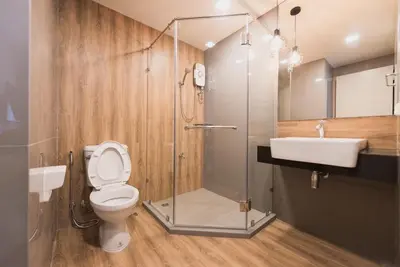 a bathroom with a shower and a toilet and a sink at W2 RESIDENCE in Ban Zong Katiam