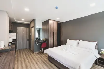 a bedroom with a large white bed and a desk at W2 RESIDENCE in Ban Zong Katiam