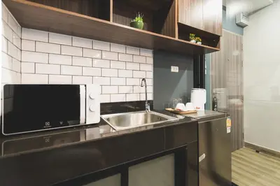 a kitchen with a sink and a microwave at W2 RESIDENCE in Ban Zong Katiam