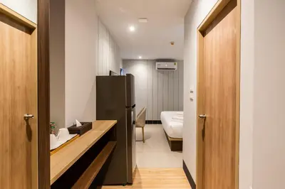 a bathroom with a black refrigerator and a sink at Hi Sotel Victory Monument in Bangkok