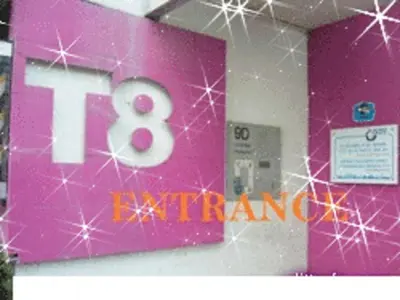 a pink sign with the number eighteenth on a wall at T8 Guest House Don Mueang Challenger in Ban Song Hong