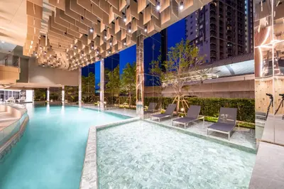 a pool in the middle of a building at Oakwood Suites Tiwanon Bangkok in Nonthaburi
