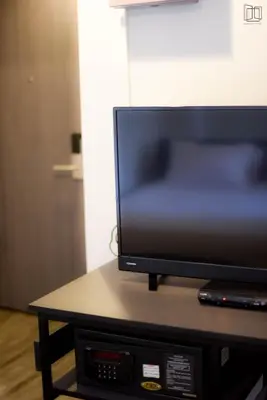 a flat screen tv sitting on top of a table at Nana City Hotel in Bangkok