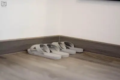 a row of white objects on the floor of a room at Nana City Hotel in Bangkok