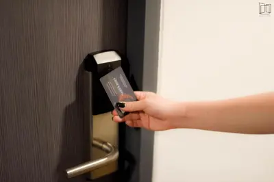 a hand holding a remote control in a door at Nana City Hotel in Bangkok