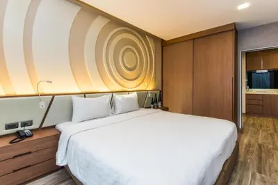 a bedroom with a large white bed in a room at Olive Hotel Bangkok 64 in Bangkok