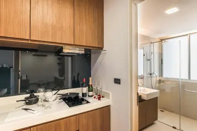 a kitchen with a sink and a stove top oven at Olive Hotel Bangkok 64 in Bangkok