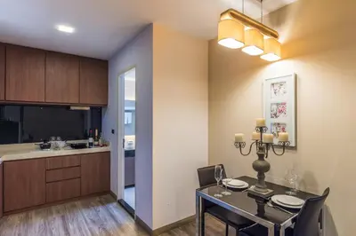a dining room and kitchen with a table and chairs at Olive Hotel Bangkok 64 in Bangkok