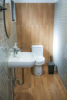 a bathroom with a white toilet and a sink at SLEEP SLEEP SUANPHAK Homestay in Ban Khlong Bang Sai