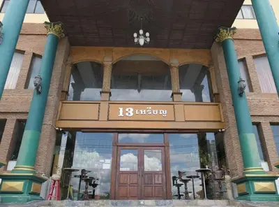 a front door of a building with a sign on it at OYO 75466 -13 Coins Bang Yai Hotel in Ban Sai Ma