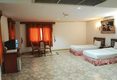 a hotel room with two beds and a television at OYO 75466 -13 Coins Bang Yai Hotel in Ban Sai Ma