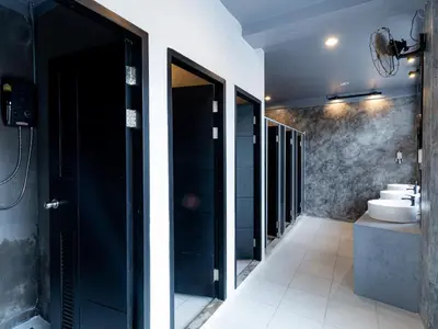 a bathroom with a walk in shower and a sink at Khao San Social Capsule Hostel in Bangkok