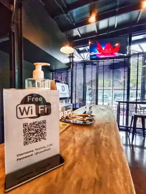 a bar with a free wifi sign on a table at Room@Doze in Nonthaburi
