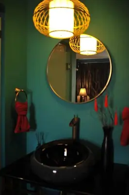a bathroom with a sink and a mirror at Caiyong Hometel & Cafe's Studio in Khlong San