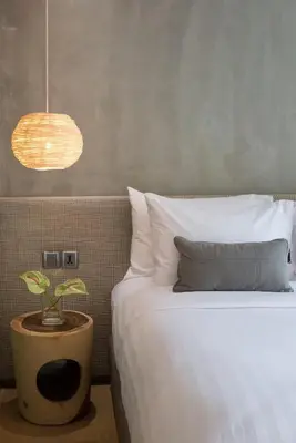 a bedroom with a bed with a potted plant on it at Ad Lib Hotel Bangkok in Bangkok