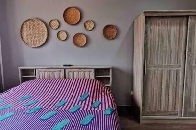 a bedroom with a bed and some mirrors on the wall at 8FINITE House in Bang Su