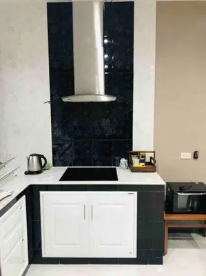 a kitchen with a black and white counter top at 8FINITE House in Bang Su