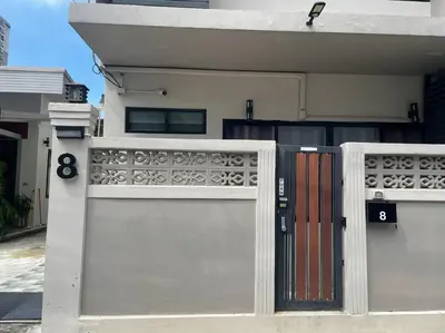 a pair of gates in front of a house at 8FINITE House in Bang Su