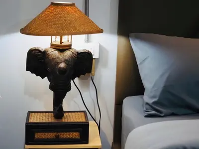 an elephant lamp on a night stand next to a bed at Wild Ones Hostel in Bangkok