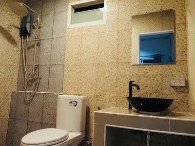 a bathroom with a toilet and a sink at Wild Ones Hostel in Bangkok