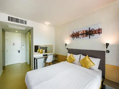 a hotel room with a bed and a desk at Kitzio House Hotel Huai Kwang in Bangkok