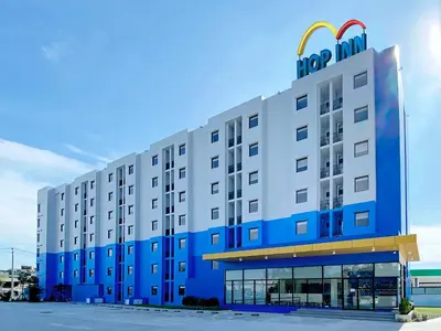 a hotel building with a mcdonalds sign on it at HOP INN Bangkok Bangna in Bangkok