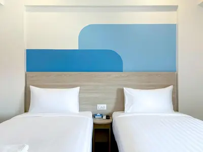 two beds sitting next to each other in a room at HOP INN Bangkok Bangna in Bangkok