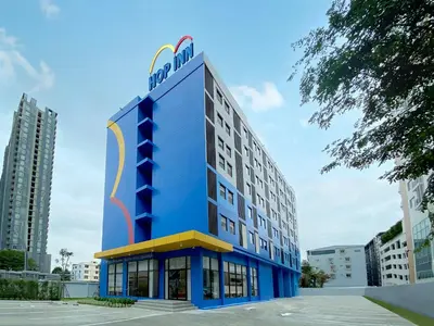 a blue building with a sign on top of it at HOP INN Bangkok Krung Thonburi Station in Bangkok
