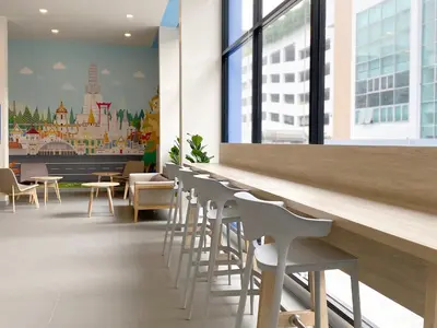 a row of white chairs and tables in a restaurant at HOP INN Bangkok Krung Thonburi Station in Bangkok
