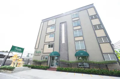 a hotel building with a fountain in front of it at หรรษาเพลส ลาดพร้าว 124 in Ban Bang Toei (1)