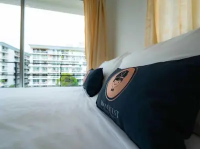 a bedroom with a bed with a large window at RQ Bangkok Sukhumvit 50 by Collection O in Amphoe Phra Khanong