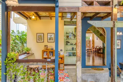a shop with blue walls and wooden beams at Priya Boutique House in Bangkok