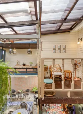 a living room with a wooden ceiling with beams at Priya Boutique House in Bangkok