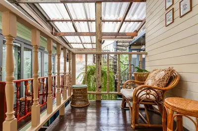 a porch with rocking chairs and a glass ceiling at Priya Boutique House in Bangkok