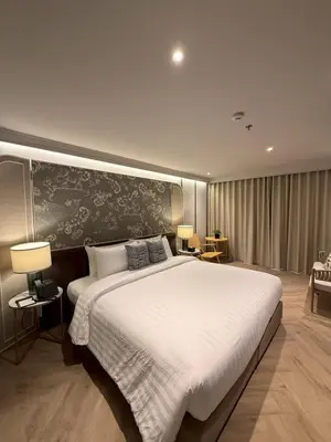 a bedroom with a large white bed in a room at The Quarter Chaophraya by UHG in Bangkok