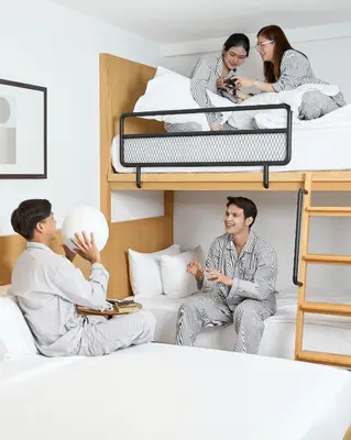 a group of people sitting on bunk beds at Livable Hotel Bangkok in Bangkok